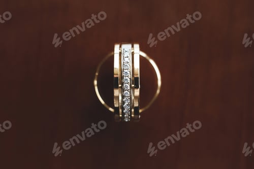 Preview: Wedding rings on wooden background