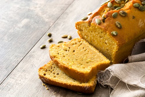Preview: Sliced pumpkin bread with pepitas on rustic wooden table