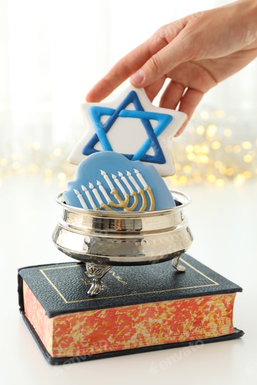 Preview: Book, gingerbread cookies in silver box and hand on light background