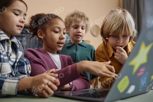 Preview: Diverse Group of School Children Looking at Computer Screen Together