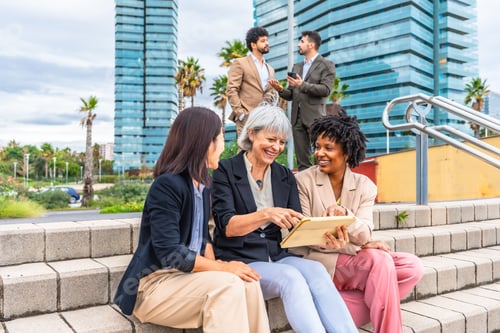 Preview: Happy businesswoman using digital tablet during outdoors meeting