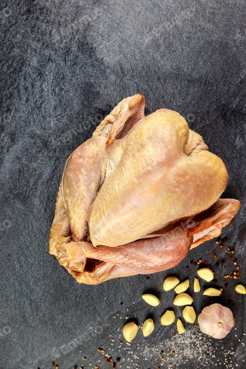 Preview: Prepare raw organic turkey with spices and garlic for roast.