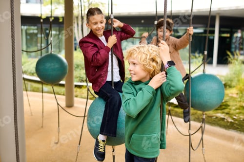 Preview: Children are happily playing on unique outdoor equipment surrounded by autumn colors and trees