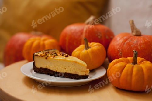 Preview: Piece of a pumpkin pie with pumpkins for autumn dessert for thanksgiving festive dinner