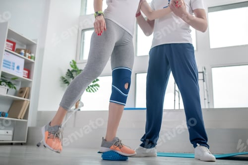 Preview: Supportive therapist assisting woman with physical therapy