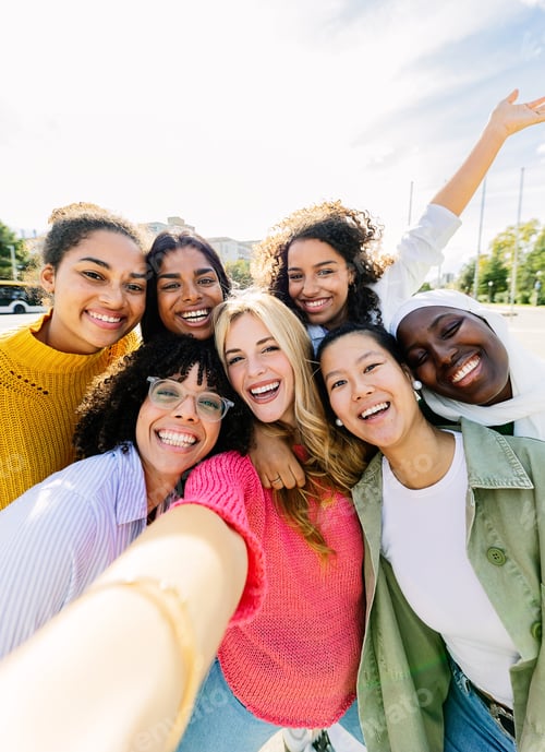 Preview: Multiracial group of seven cheerful women having fun taking selfie portrait