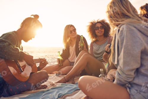Preview: Group of friends partying on the beach at sunset