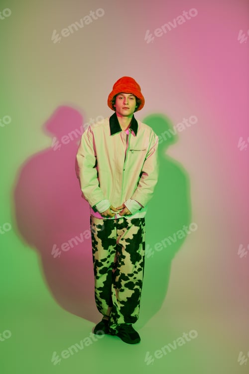 Preview: Young man embodies modern fashion trends with unique style and vibrant colors in urban setting
