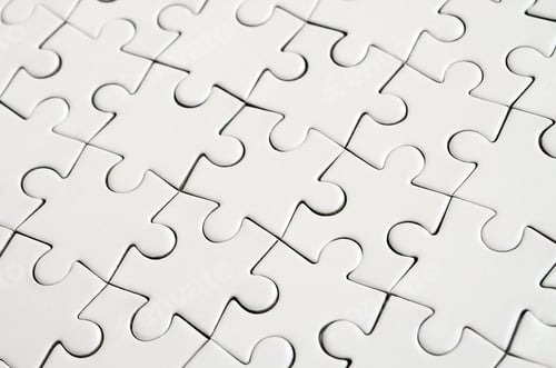 Preview: Close up of a white jigsaw puzzle in assembled state in perspective