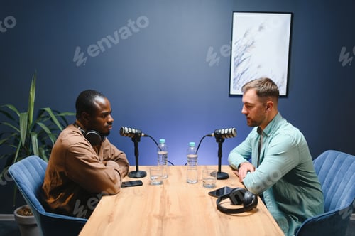Preview: Man recording podcast using high tech microphones to interview guest