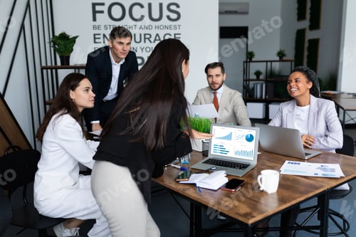 Preview: Competent IT specialists in stylish outfit working on modern gadgets while sitting together at
