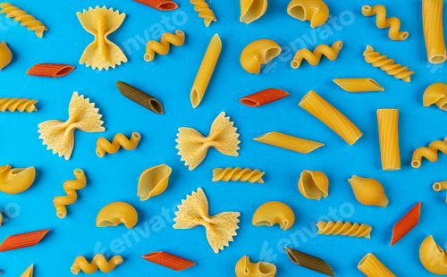 Preview: Different pasta types on blue background, top view, flat lay composition