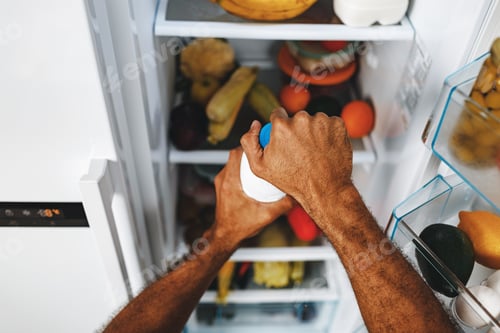 Preview: Male hands taking bottle of milk from a fridge