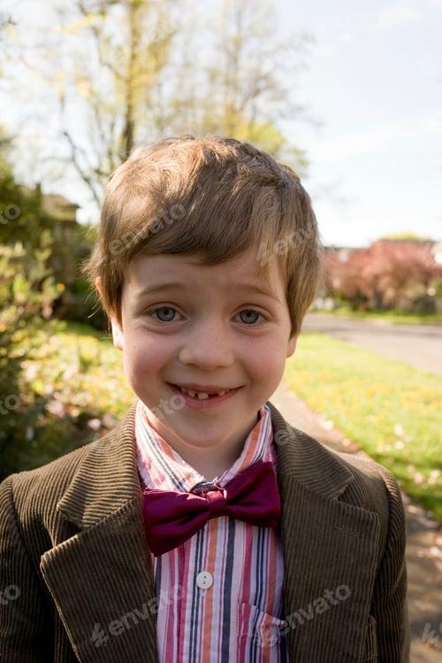 Preview: Young boy smiling outdoors on a sunny day