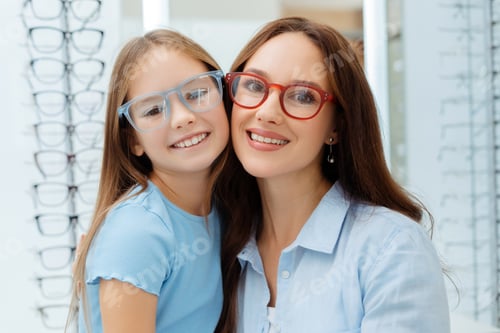 Preview: Smiling mother and daughter in glasses posing in optics