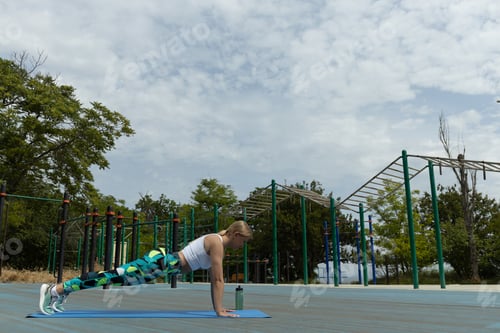 Preview: Strong athletic woman doing exercises on sports field, space for text