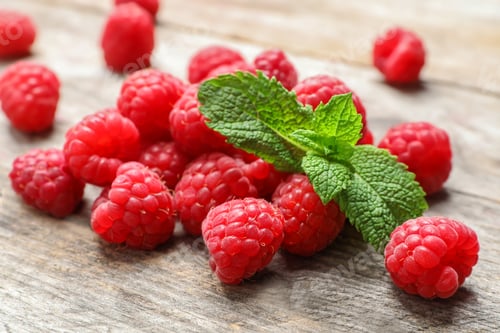 Preview: Ripe aromatic raspberries on wooden table