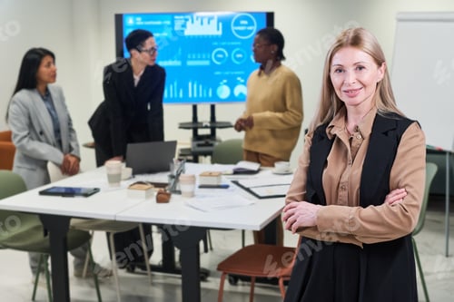 Preview: Portrait of Middle Aged Caucasian Woman Standing Confidently in Office Meeting