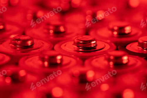 Preview: Closeup of positive ends of discharged batteries AA sizes, macro shot, selective focus. Used battery