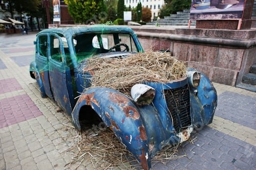 Preview: Old abandoned car with hay on engine