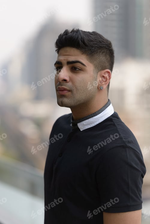 Preview: Portrait of young handsome Indian man in the city