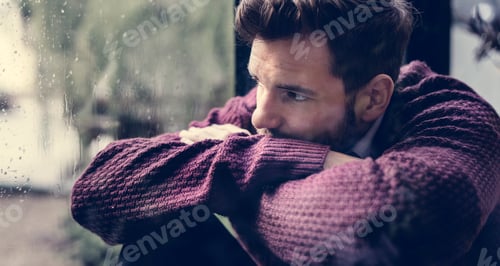 Preview: Thoughtful man looking out the window