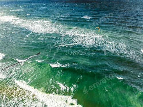 Preview: Outstanding kitesurfer on big waves at Baltic Sea.