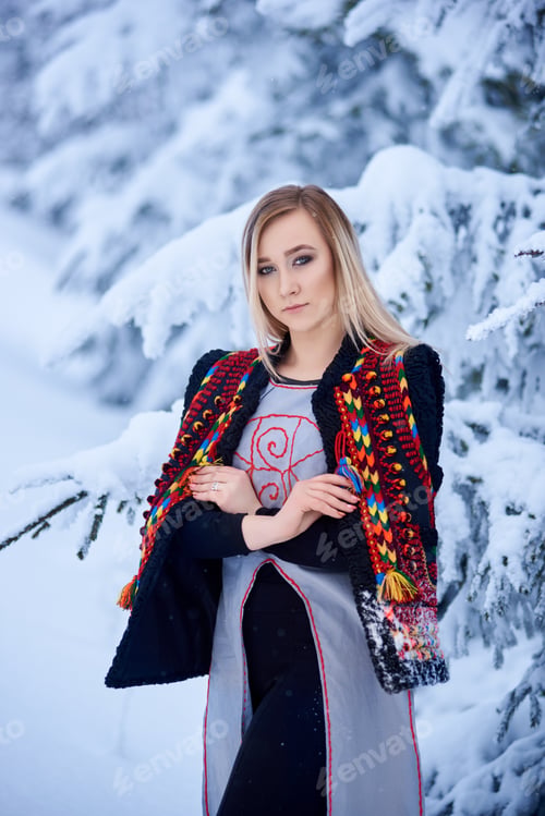 Preview: Young attractive woman in white fur coat. Traditional women's attire of western part of Ukraine.