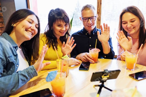 Preview: Friends Waving at Phone at Table with Drinks