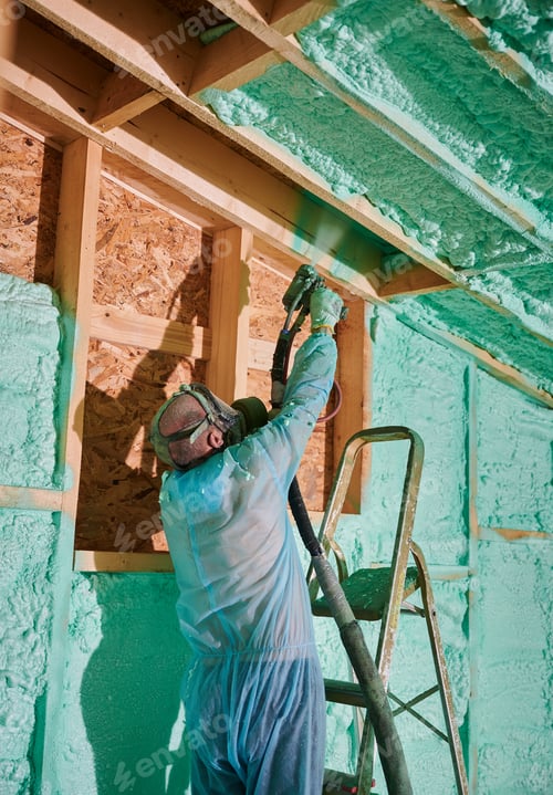 Preview: Worker spraying polyurethane foam for insulating wooden frame house.