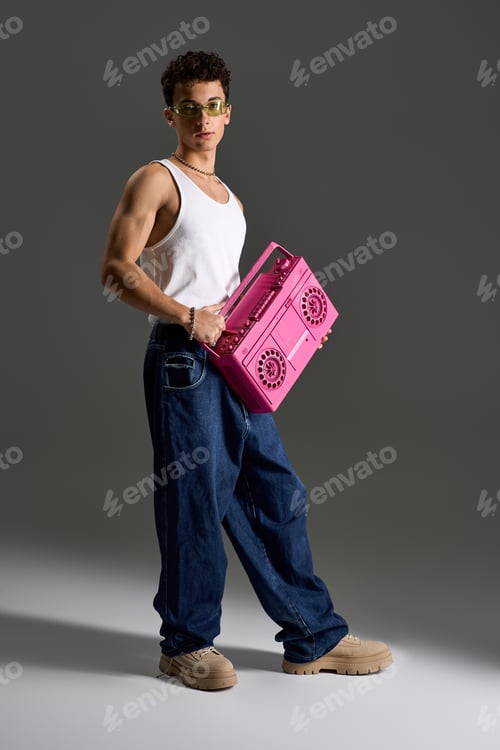 Preview: Curly teenager exudes style in tank top and sunglasses with a retro boom box
