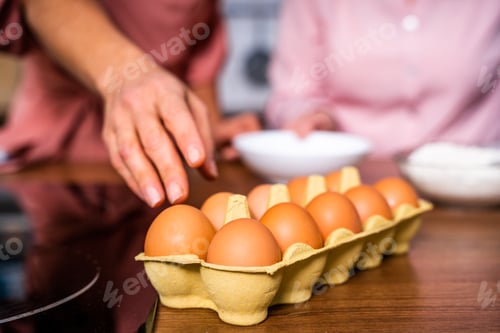 Preview: Beautiful senior woman and daughter baking in the kitchen