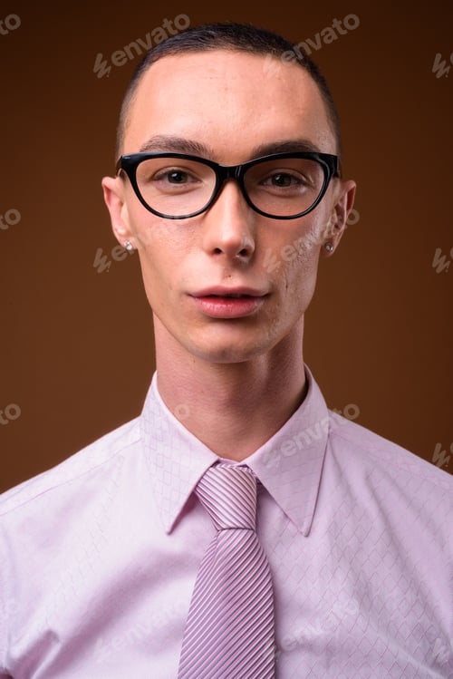 Preview: Elegant Young Adult with Glasses on Brown Background