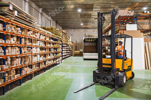 Preview: Worker driving forklift in lumberyard warehouse