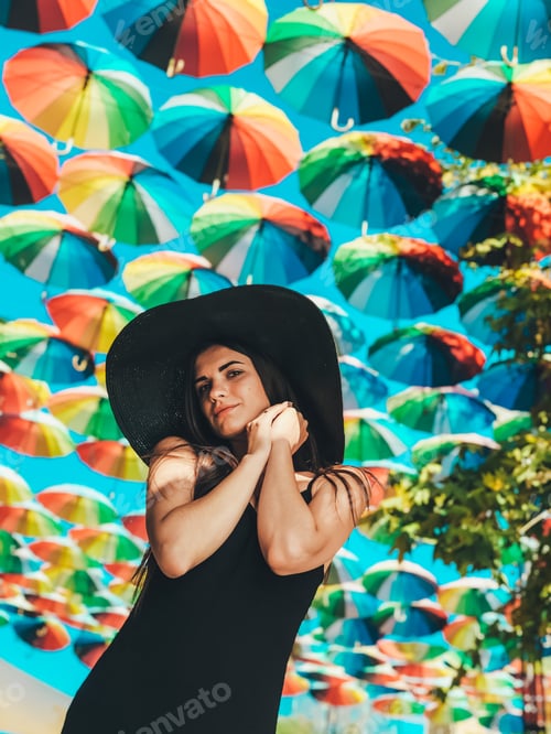 Preview: Portrait of a girl in black under colorful umbrellas