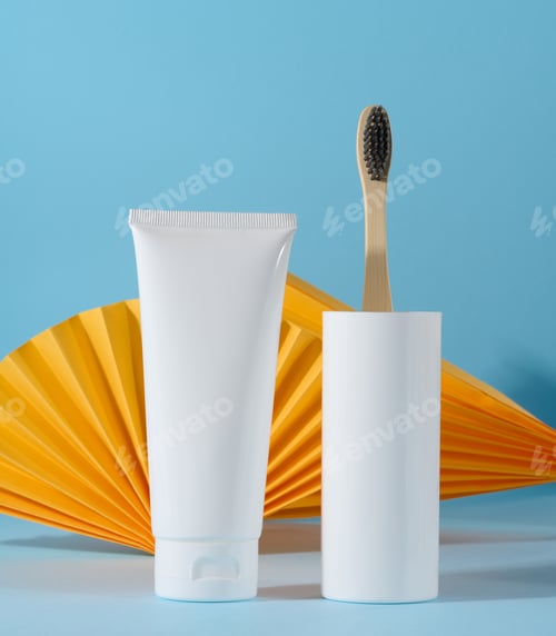 Preview: White plastic toothpaste tube and toothbrush on a blue background