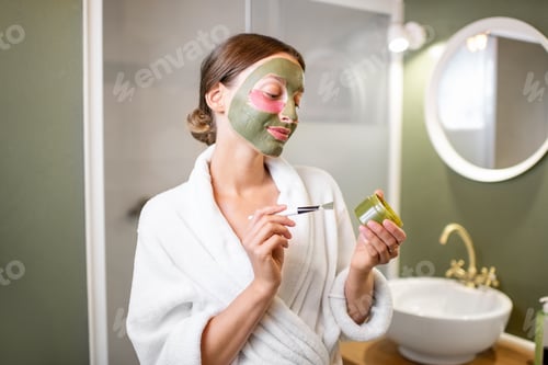 Preview: Woman with facial mask and patches in the bathroom