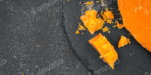Preview: Aged cheese Mimolette or cheddar fresh tasty food dish delicious gourmet food background