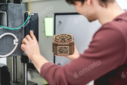 Preview: male worker carve wood with laser system b