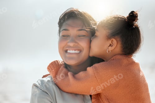 Preview: Adorable mixed race girl kisses her mother on the cheek and outs her arms around her while at the b