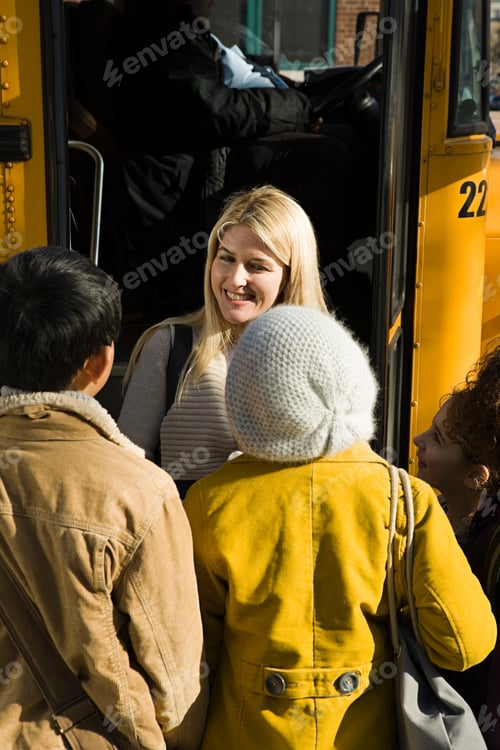 Preview: Children and teacher by school bus