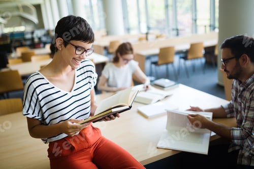 Preview: Group of Young Students Studying together at Library