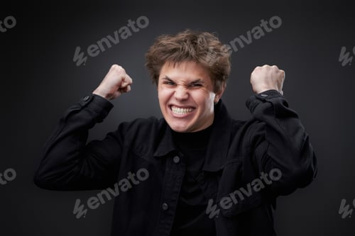 Preview: annoyed angry man in furious gesture on black background