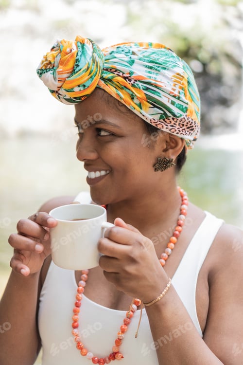 Preview: Latin woman drinking coffee by the river