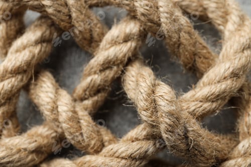 Preview: Thick knotted rope close-up on gray background