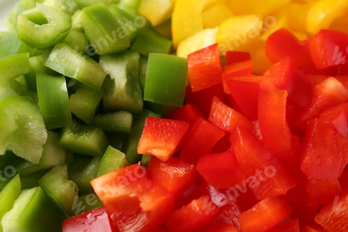 Preview: Pieces of fresh colorful bell peppers as background, closeup