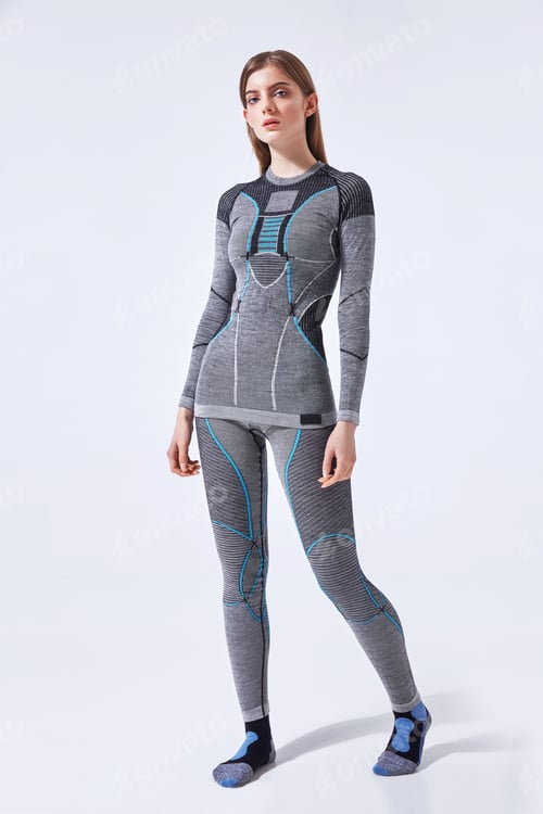 Preview: Young woman in hot sports thermal underwear on isolated studio background