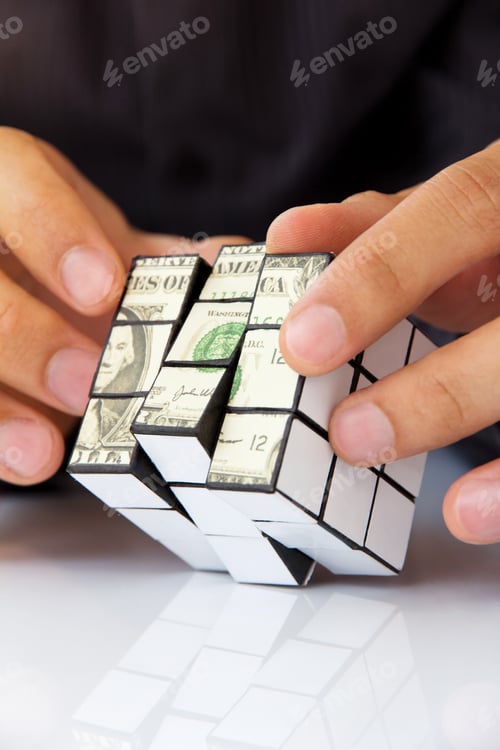 Preview: Business man hand holding a rubik's cube