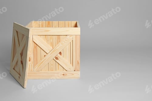 Preview: Open wooden crate on grey background. Space for text