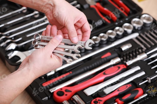 Preview: Tool store. Closeup of male hand holding wrenches. Auto repair kit in toolbox. Repairman